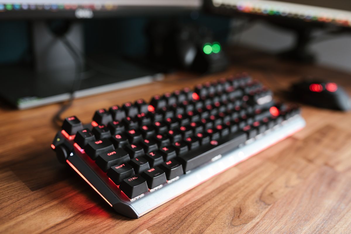 A compact 60 percent keyboard on a wooden desk