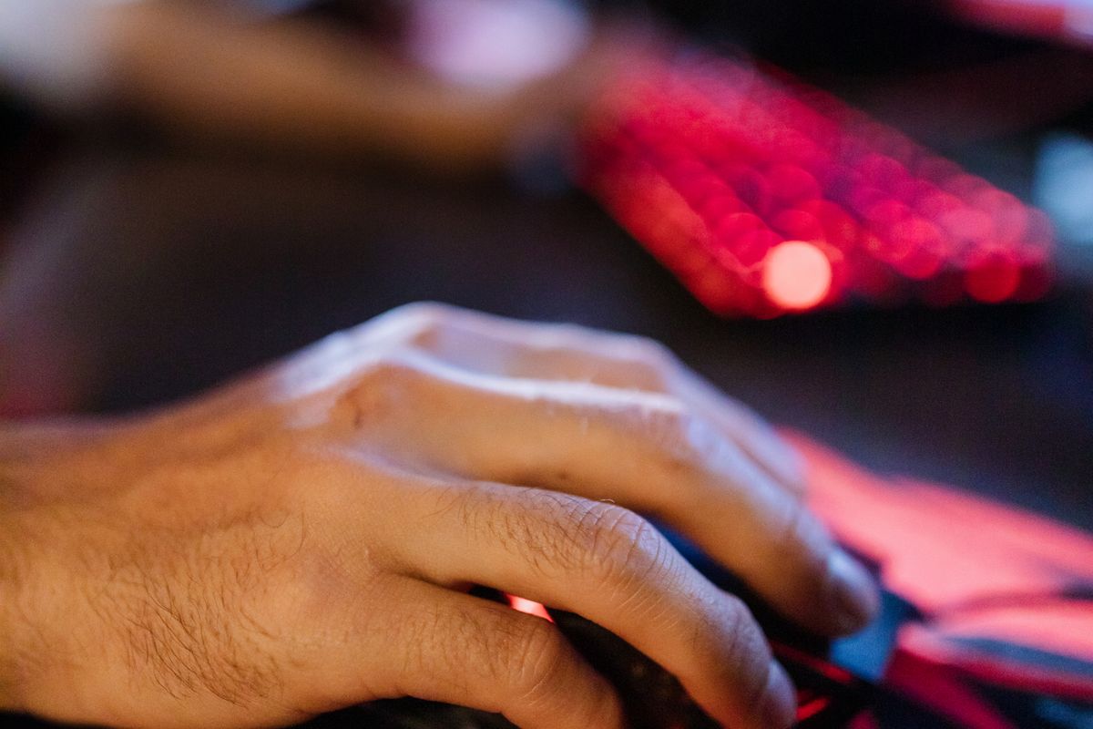 A gaming mouse on a desk mat beside a keyboard